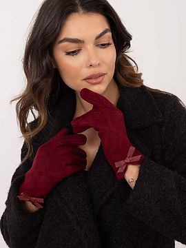 Mănuşi AT  Mănuși elegante pentru femei din material călduros cu un model interesant. La încheieturi, fundițe decorative. Degetul arătător cu o 