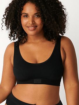 Sutien sportiv Sloggi  Top sportiv negru Double Comfort 10022574 de la brandul Sloggi a fost creat pentru femeile care doresc confort maxim atât în timpul activi